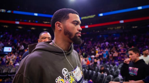 Caleb Williams stands during a Phoenix Suns game.